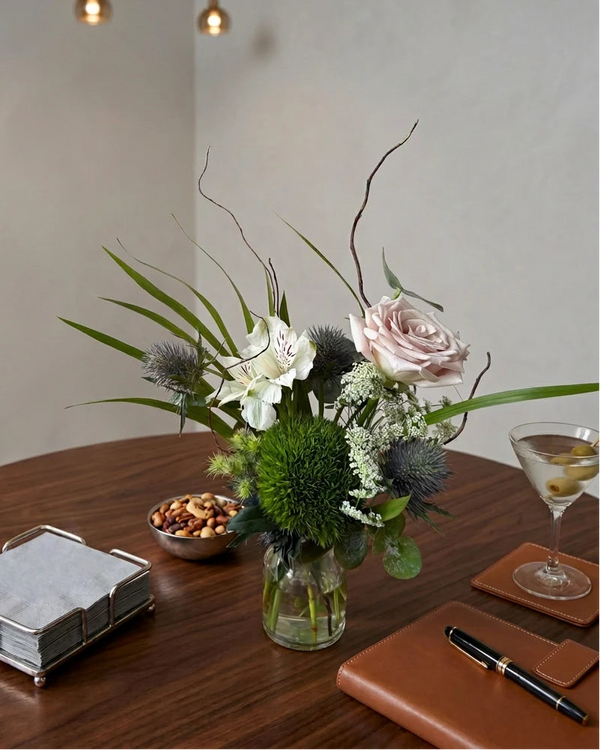 Fresh Bud Vase — pink rose, white alstroemeria, green button mum and thistle in a glass vase on a dining table