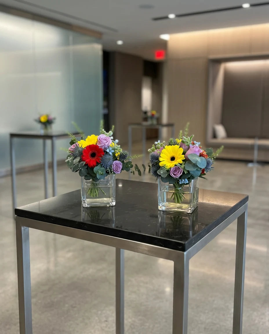 Corporate cocktail table flower arrangements in a modern office lobby event setting
