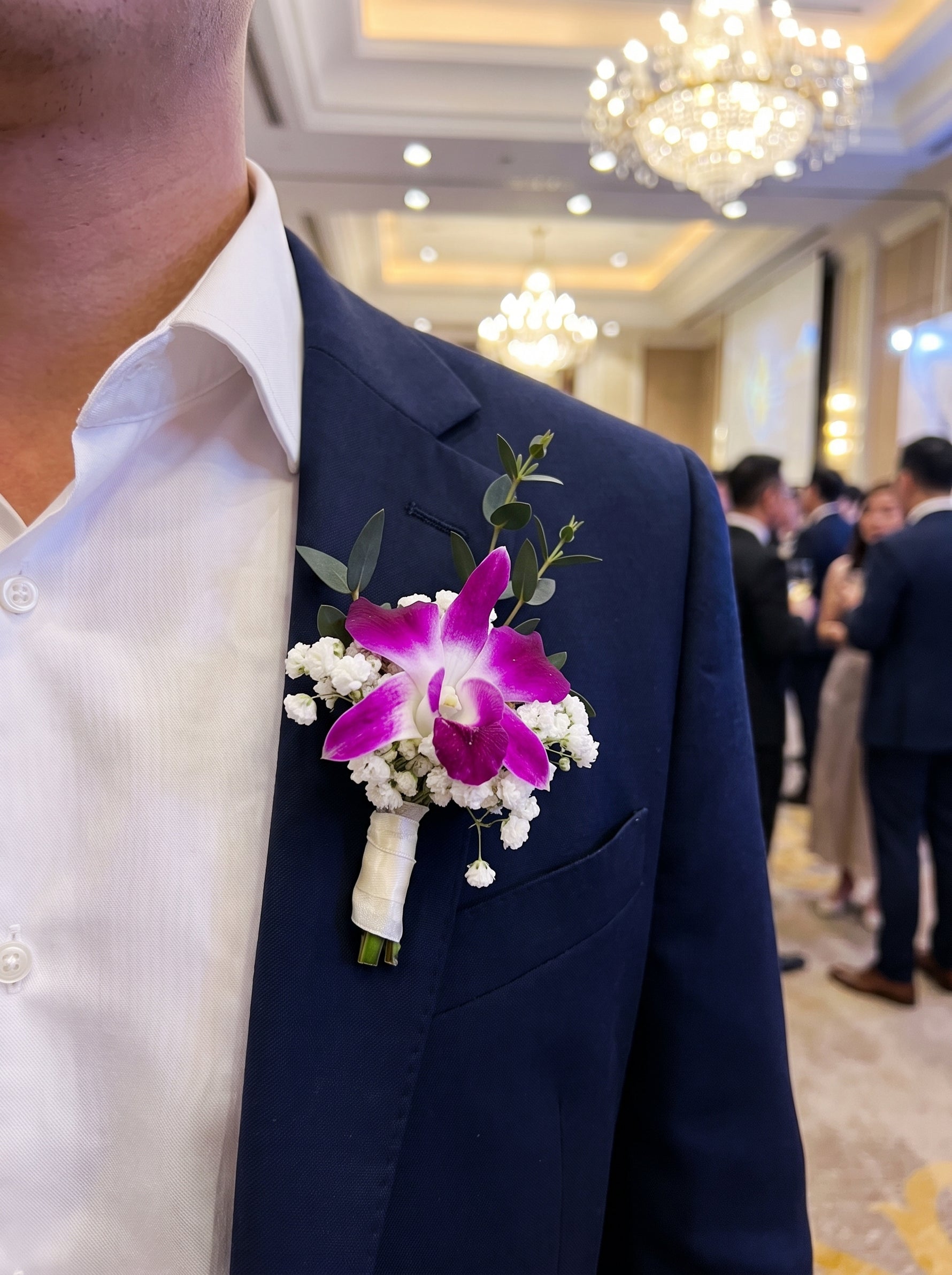 Corporate Boutonniere (Fresh, purple orchid) worn on a navy blazer at a corporate gala