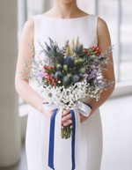Modern bride holding the Eryngium Blooms Bridal Bouquet