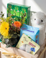 Close-up of premium baby hamper Singapore showing Bird's Nest, BZU BZU travel kit and seasonal bouquet