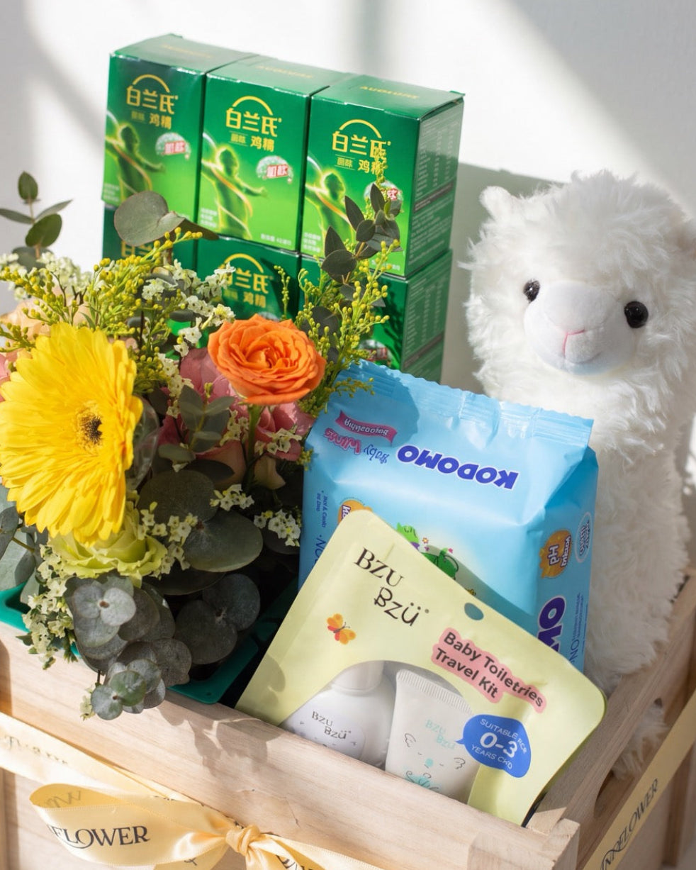 Close-up of premium baby hamper Singapore showing Bird's Nest, BZU BZU travel kit and seasonal bouquet