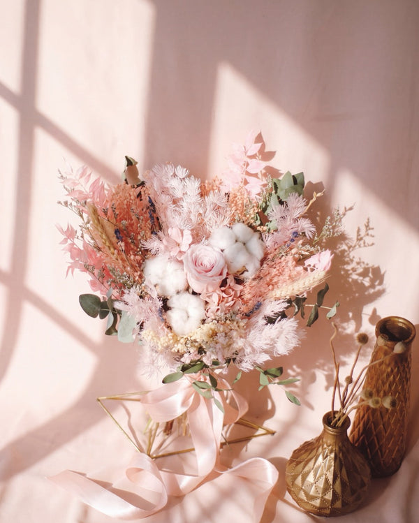 Eternal Pink Bridal Bouquet — preserved pink rose, cotton bolls and dried blush-pink foliage on a pink backdrop.