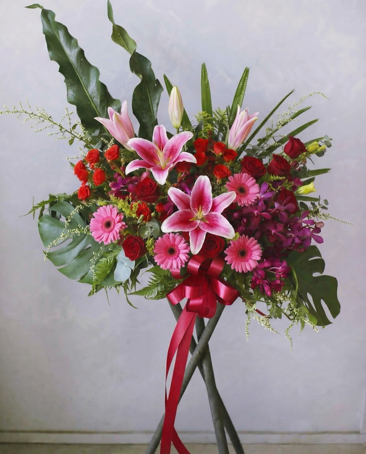 Crimson Elation congratulatory flower stand with red blooms, Singapore same-day delivery