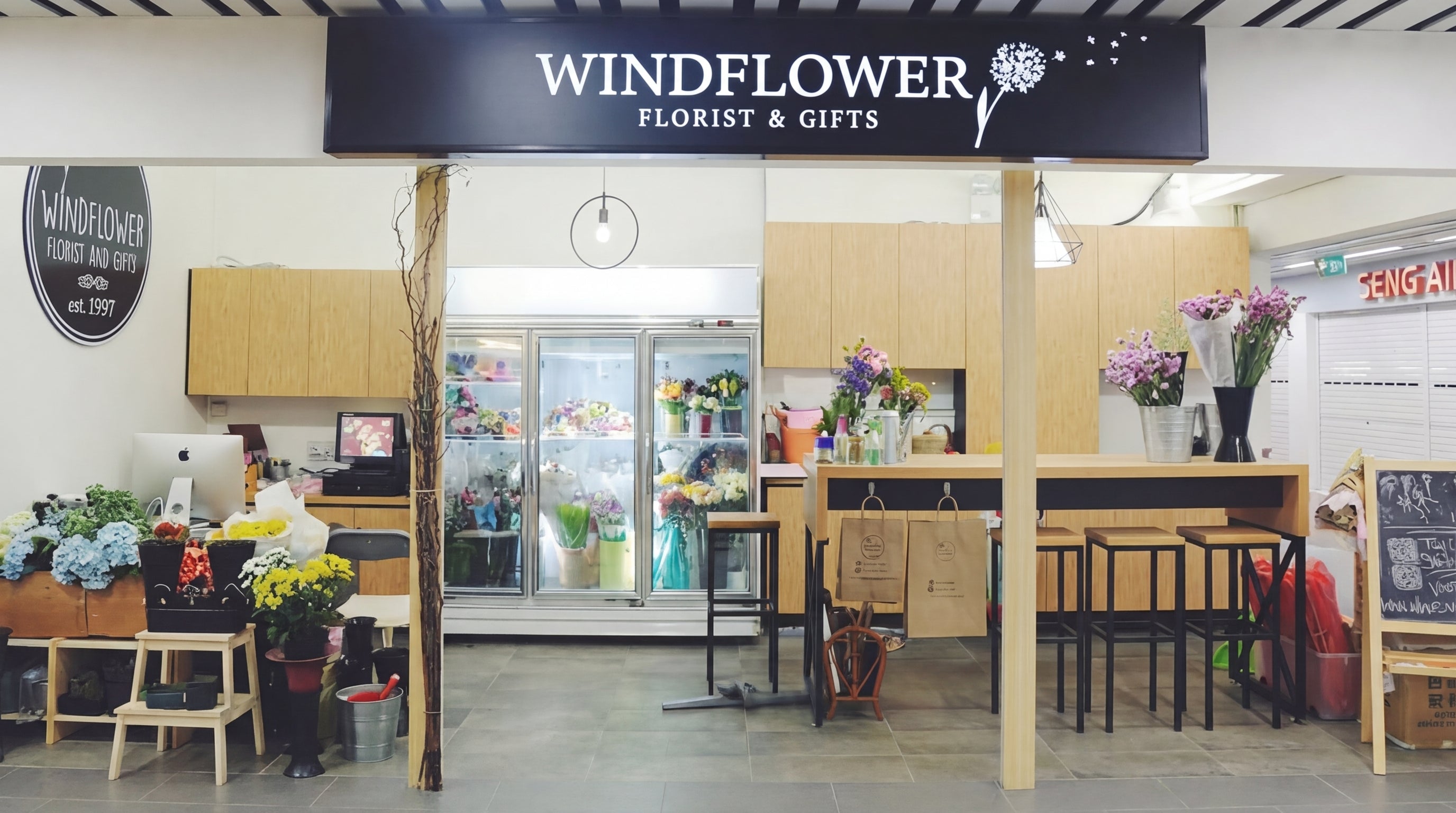 Renovated Windflower Florist storefront at Loyang Point with flower display cooler and kraft paper aesthetic