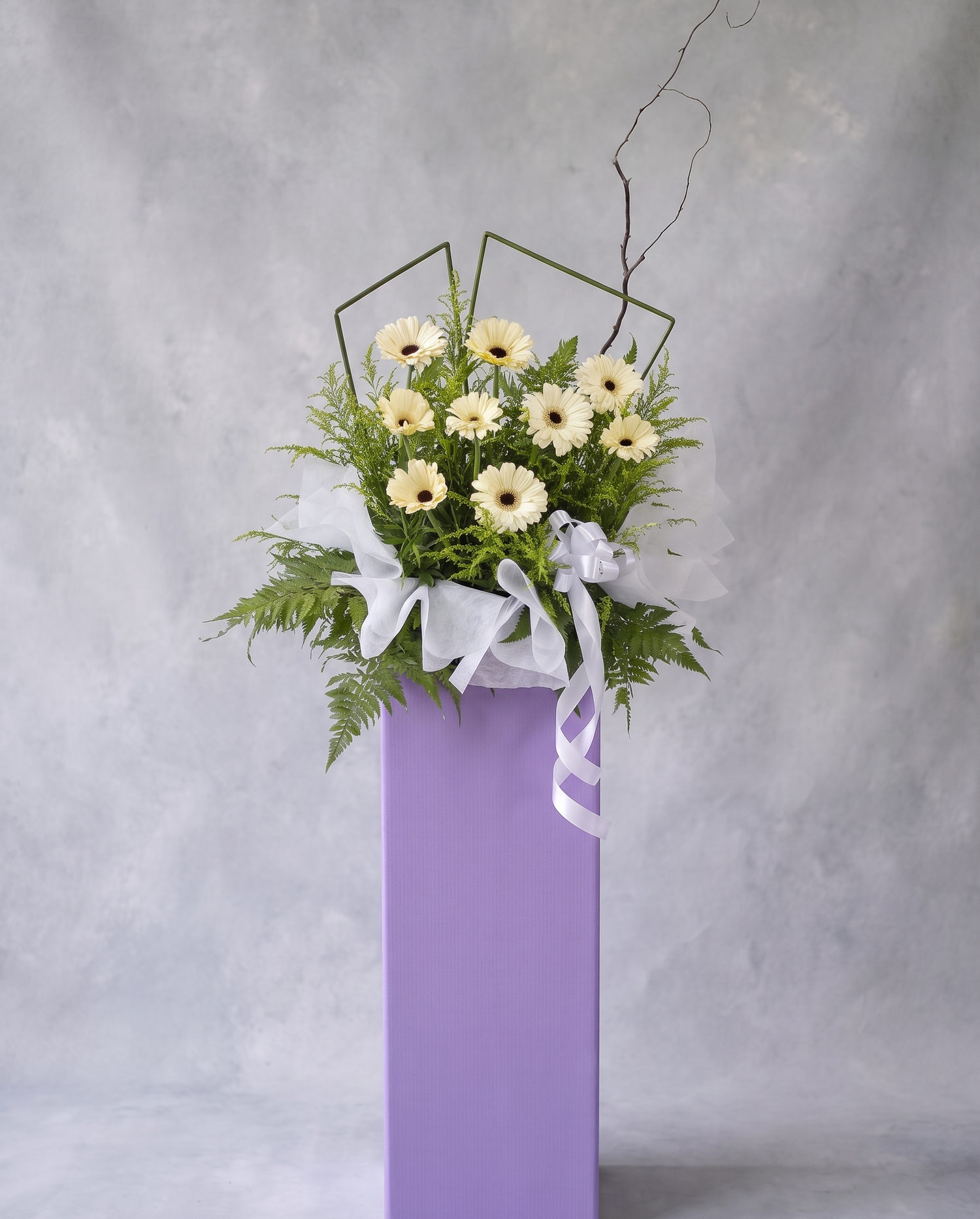 Cream Serenity condolence flower stand, full view with cool grey backdrop