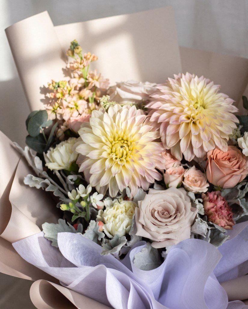 Kumo — close-up of cream dahlias, taupe roses and dusty miller