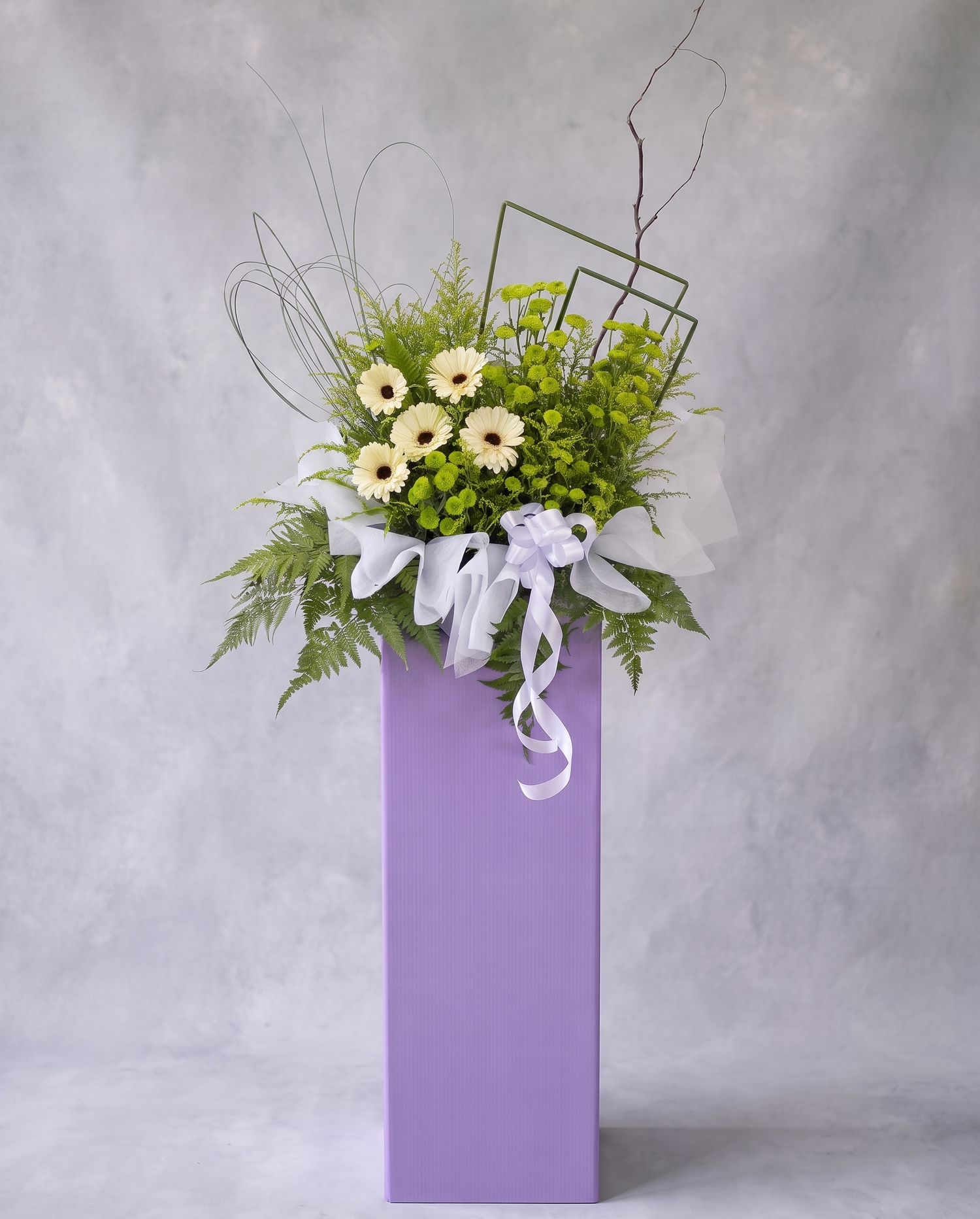 Lilac Meadow condolence flower stand, full view with cool grey backdrop