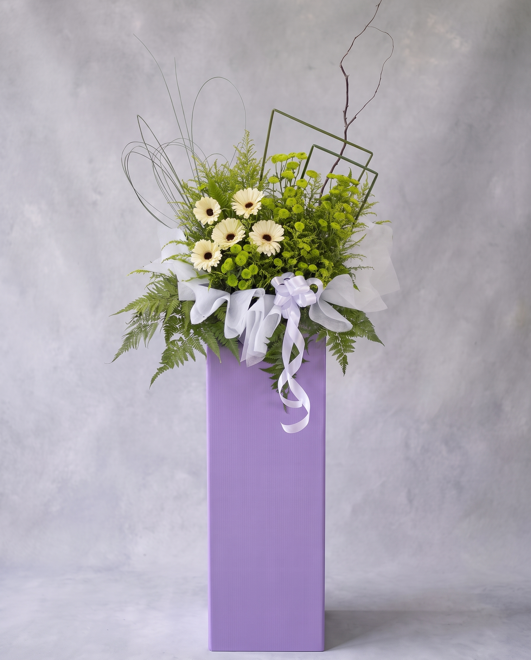 Lilac Meadow condolence flower stand, full view with cool grey backdrop