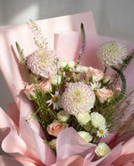 Mochi — close-up of pale pink dahlias, blush roses and chamomile