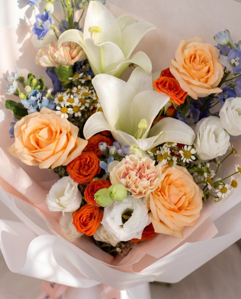 Orange Rose & White Lily Bouquet — close-up of orange roses, white lilies, lisianthus and blue tweedia