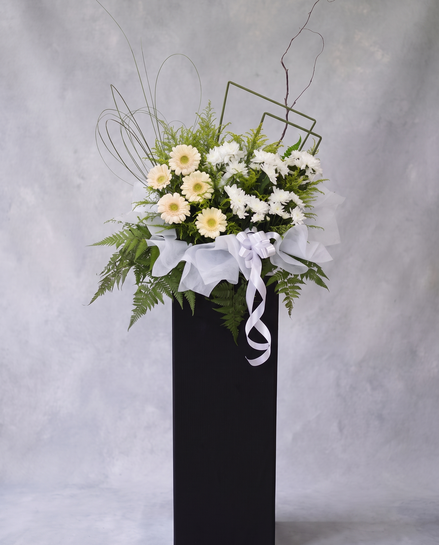 Peach Luminary condolence flower stand, full view with cool grey backdrop