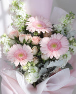 Bonbon — close-up of pink germini, spray roses and white matthiola