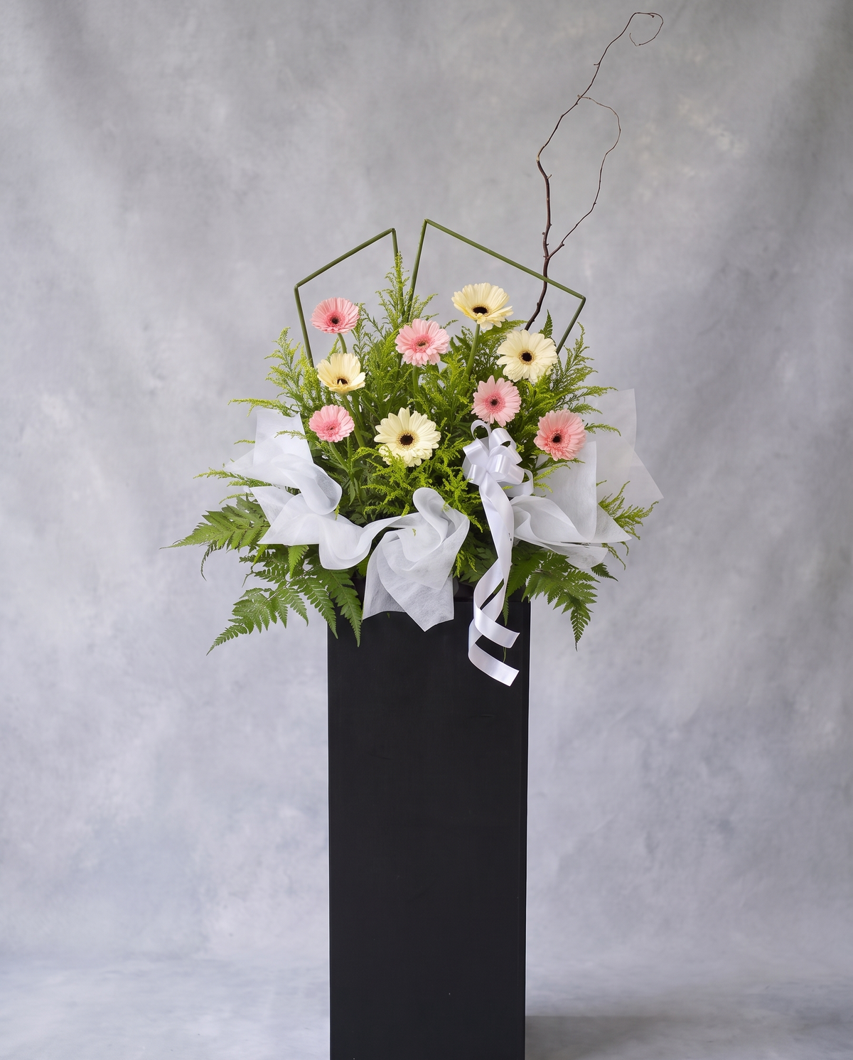 Roseate Comfort condolence flower stand, full view with cool grey backdrop