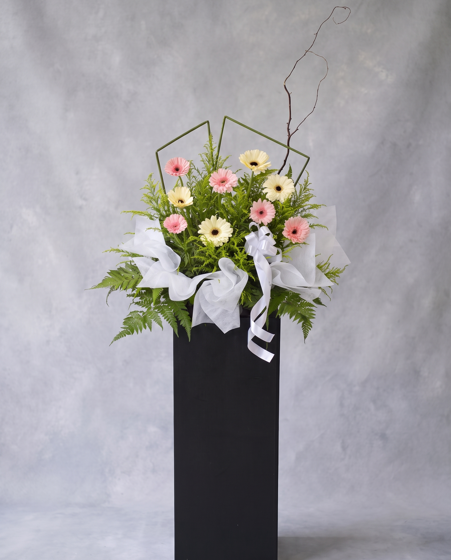 Roseate Comfort condolence flower stand, full view with cool grey backdrop