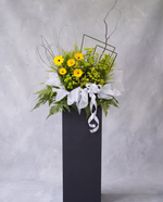 Sunlit Grace condolence flower stand, full view with cool grey backdrop